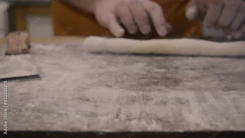 Chef rolls the dough slowmotion
The camera travels from left to right, until it reaches the black tray that has the gnocchi ready to boil.
The shot has soft blurs Chef rolls the dough slowmotion
The camera travels from left to right, until it reaches the black tray that has the gnocchi ready to boil.
The shot has soft blurs