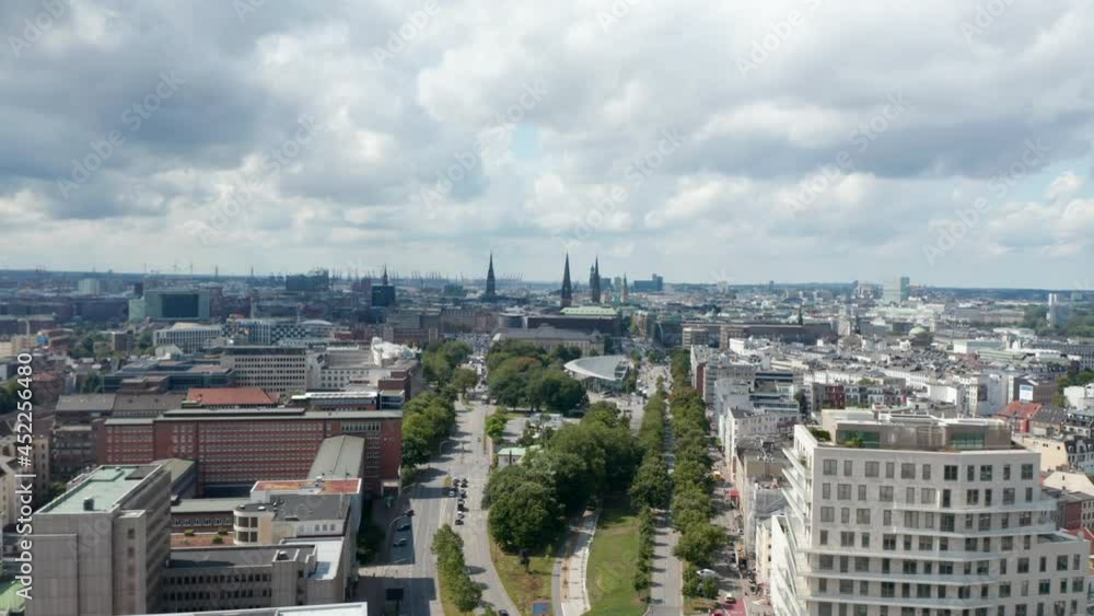 Aerial view of urban neighbourhood, flying towards historic city centre with church towers. Harbour cranes in background. Free and Hanseatic City of Hamburg, Germany Aerial view of urban neighbourhood, flying towards historic city centre with church towers. Harbour cranes in background. Free and Hanseatic City of Hamburg, Germany