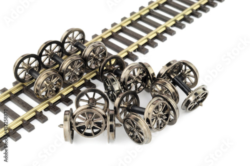 Fototapeta Naklejka Na Ścianę i Meble -  Group of metal spoked model railway wheels with axles in oo gauge or 1/76 scale