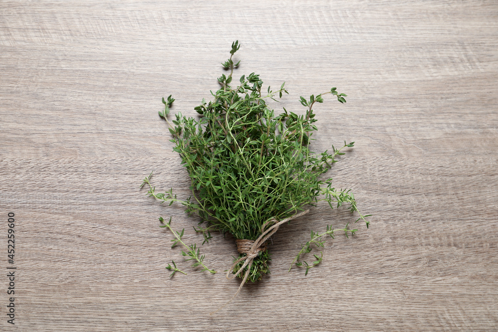 Bunch of aromatic thyme on wooden table, top view Bunch of aromatic thyme on wooden table, top view