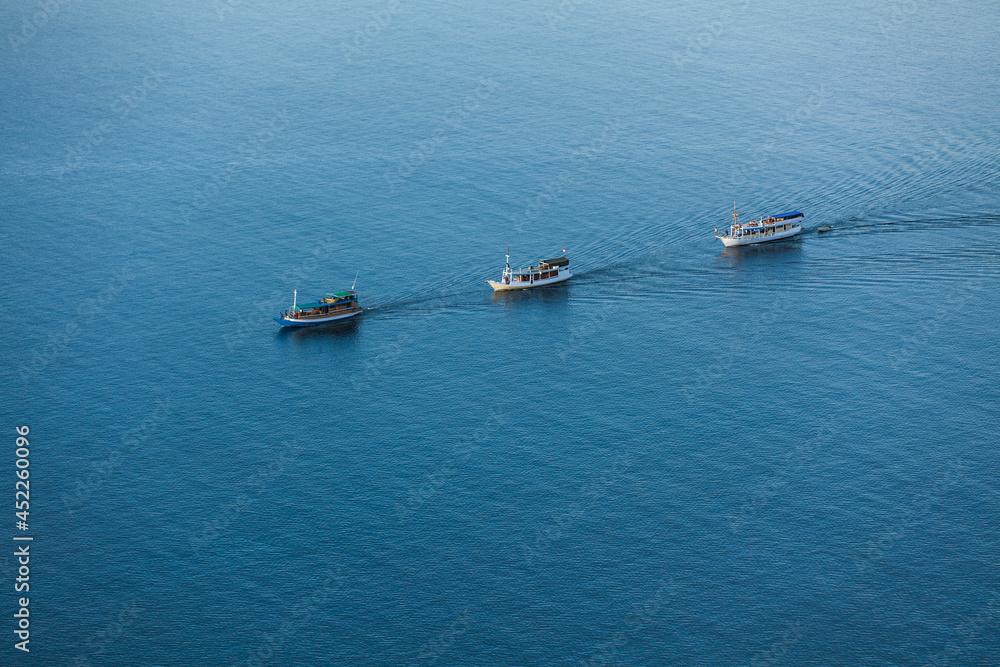 Three boats floating in the sea 