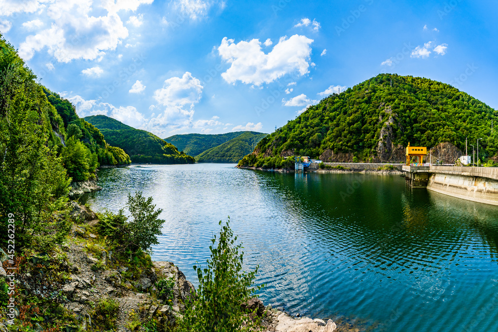 Landscape of reservoir lake Tarnita and the Tarnita Dam on Somesul Cald river surrounded by grean mountains in Cluj county, Transylvania, Romania