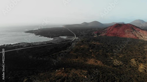 vulcanic valley with mountains in the background on a sunny day in Lanzarote Aerial Drone Footage