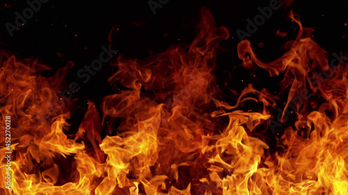 Texture of flames isolated on black background. Fire and fiery element.