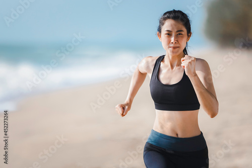 Athlete female running on beach, Exercise jogging concept