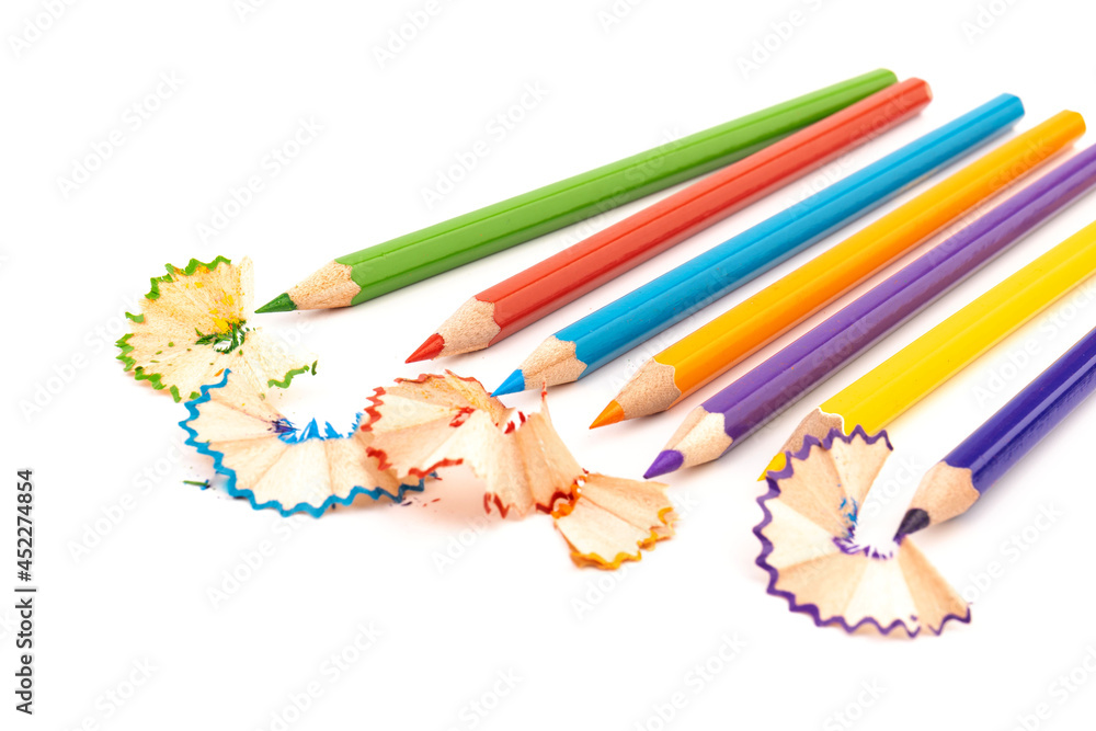 Wooden pencil whith shavings and colorful crumbs of graphite from sharpener. Back to school concept. Wooden pencil whith shavings and colorful crumbs of graphite from sharpener. Back to school concept.