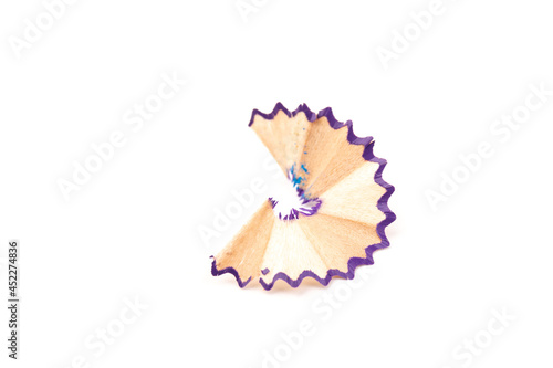 Wooden colored pencil sharpening shavings pile on white isolated background, top view, flat lay, copy space. Back to school concept.