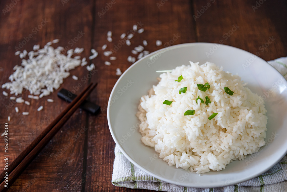 streamed rice on white plate at wooden background streamed rice on white plate at wooden background