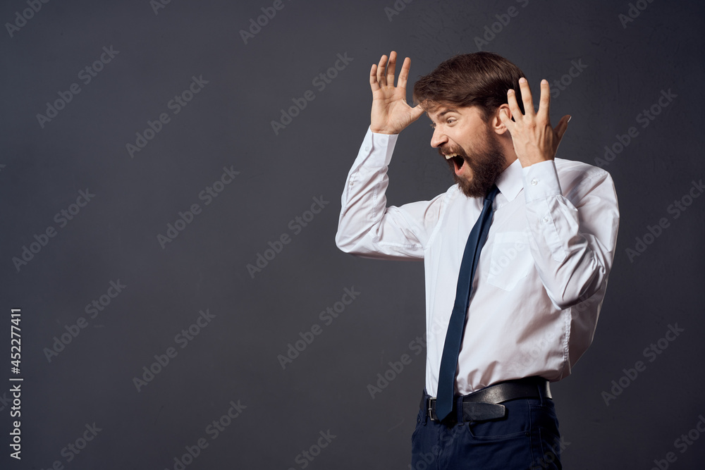 manager holding a tie executive office dark background