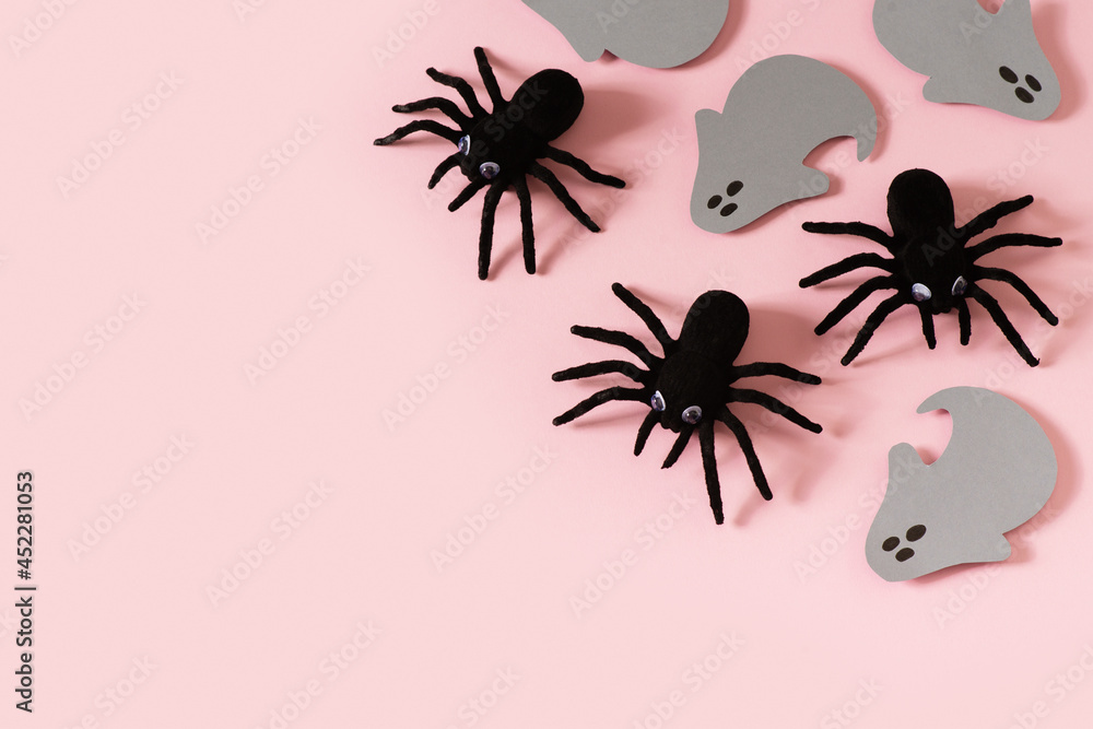 Halloween card with black spiders and grey ghost on pink background