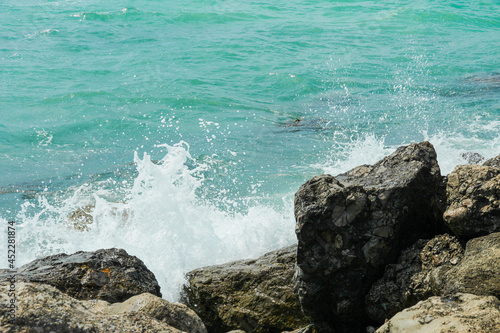 Waves crash on stones
