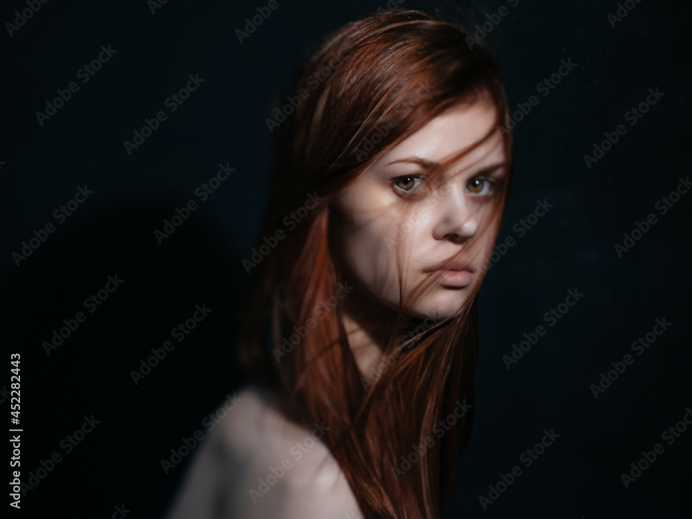 woman with bare shoulders red hair posing isolated background