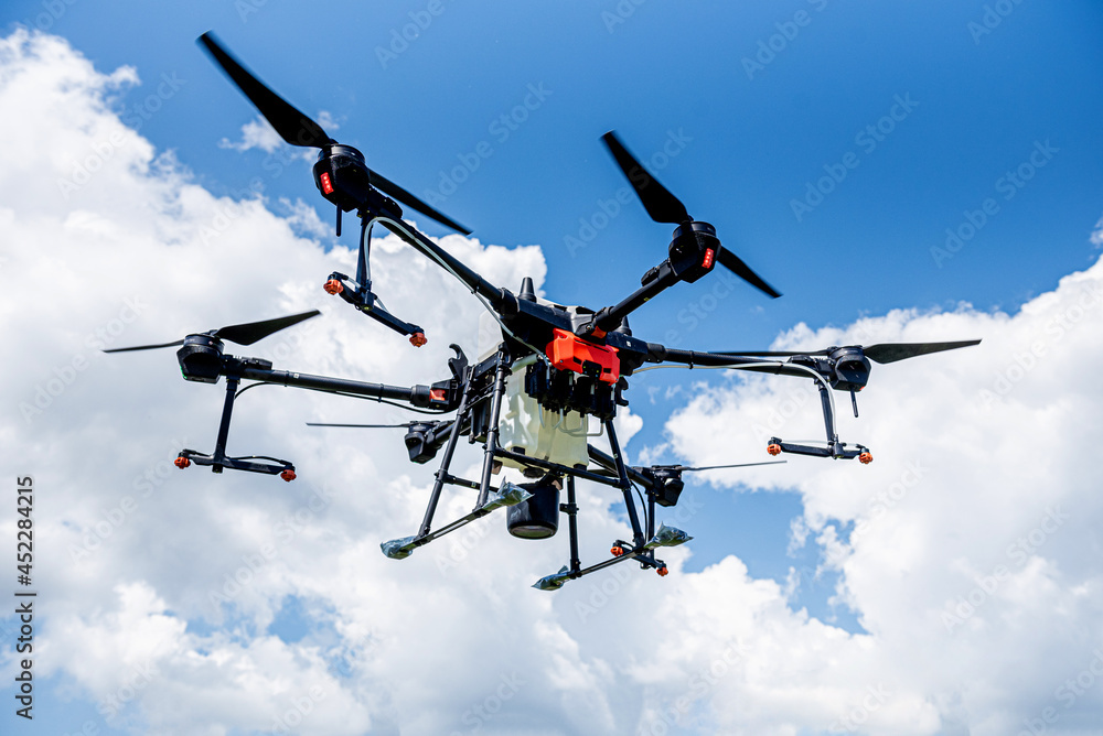 Professional agriculture drone flying in the blue sky Professional agriculture drone flying in the blue sky