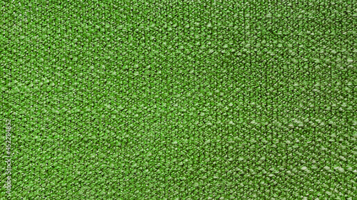 close up bright green cloth texture background showing fiber detail. vivid green sackcloth surface. woven thread background.