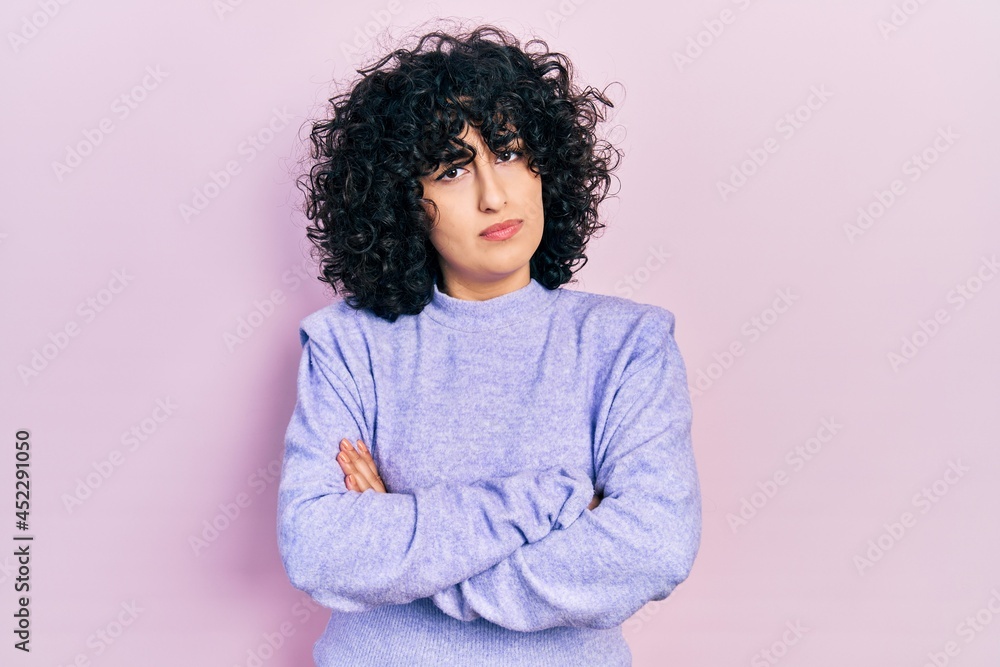 Young middle east woman wearing casual clothes skeptic and nervous, disapproving expression on face with crossed arms. negative person. Young middle east woman wearing casual clothes skeptic and nervous, disapproving expression on face with crossed arms. negative person.