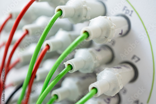 Encephalograph with green and red wires at modern medical center photo