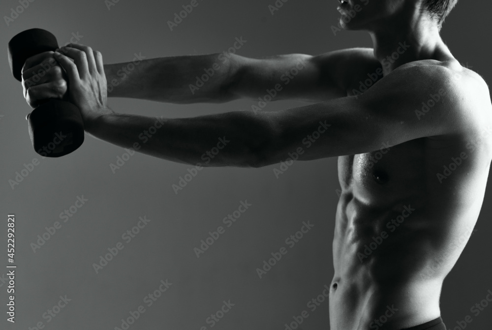 athletic man with dumbbells in hand doing exercises
