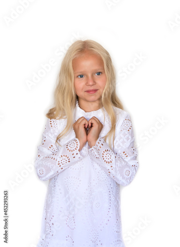 Beautiful girl in a white dress on isolated white background. Blonde with long hair. Emotions. photo