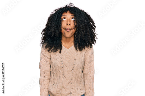 Young african american girl wearing casual clothes making fish face with lips, crazy and comical gesture. funny expression.
