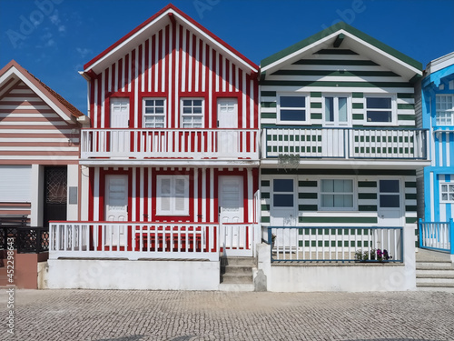 Colorful striped wooden beach houses at the promenade of Costa Nova, Aveiro, Portugal