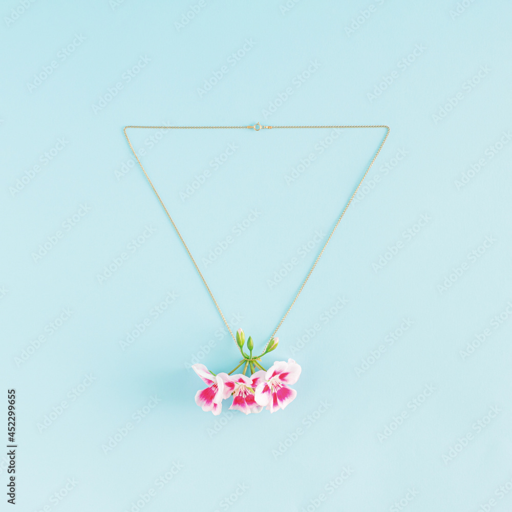 Creative idea of necklace and pink blooming flowers as pendant. Minimal .jewelry flat lay concept.