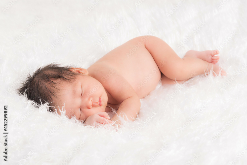 Cute newborn baby in a white blanket. Cute newborn baby in a white blanket.