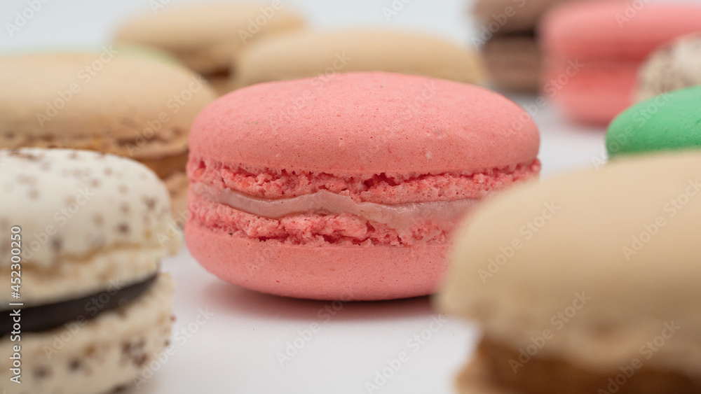 Multiple flavor Cake macaron or macaroon on turquoise macros on a white background. Multiple flavor Cake macaron or macaroon on turquoise macros on a white background.