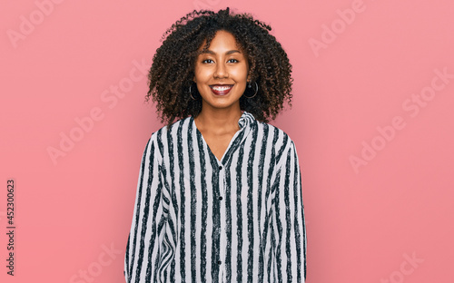 Young african american girl wearing casual clothes with a happy and cool smile on face. lucky person.