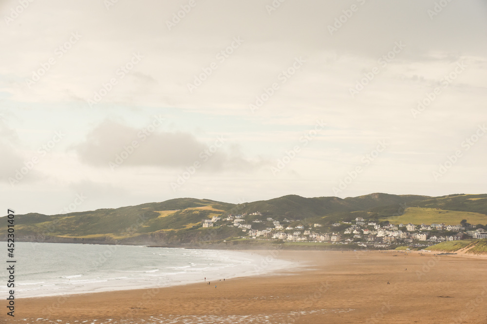 Beach view across the sand with sea shore and seaside town