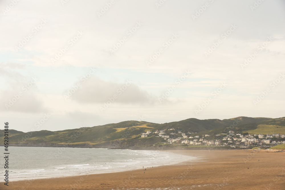 Beach view across the sand with sea shore and seaside town