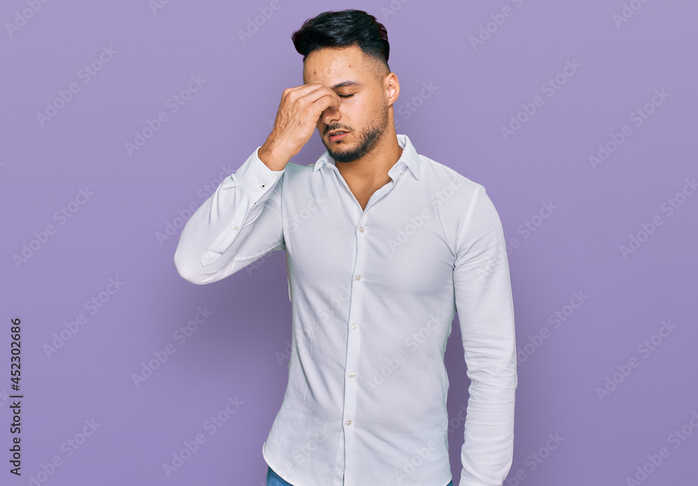 Young arab man wearing casual clothes tired rubbing nose and eyes feeling fatigue and headache. stress and frustration concept. Young arab man wearing casual clothes tired rubbing nose and eyes feeling fatigue and headache. stress and frustration concept.