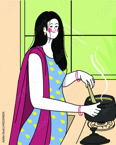 Indian woman is cooking in the kitchen on gas.