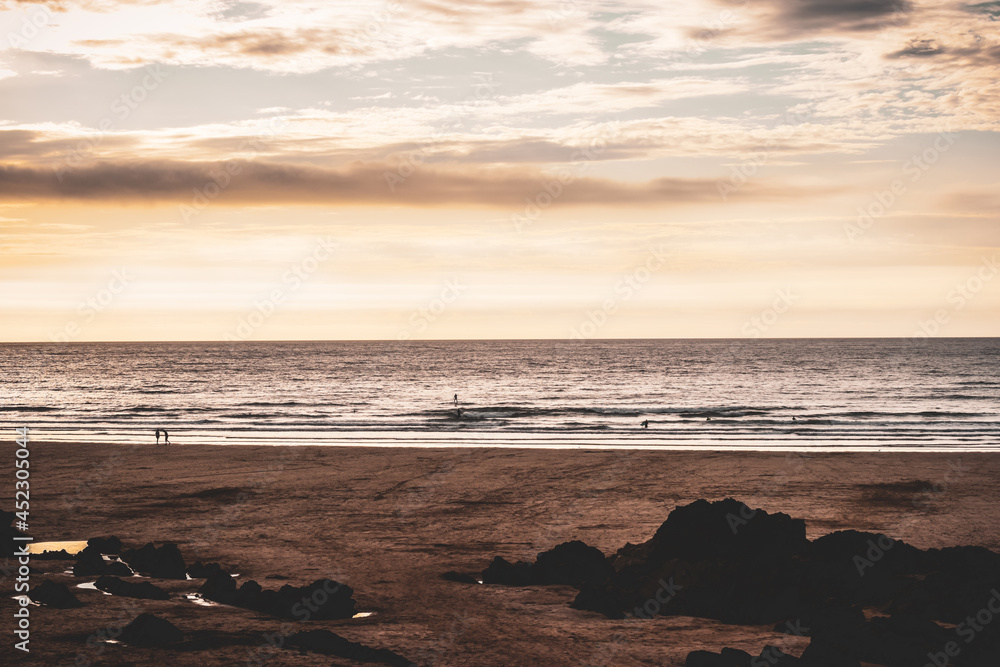 View out to sea from a beach at sunset