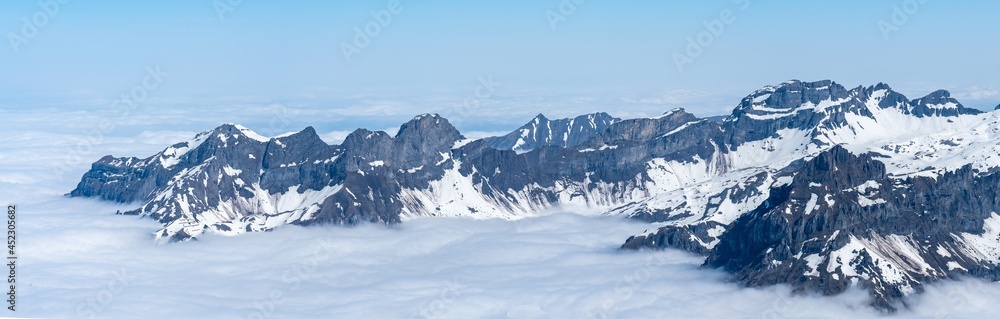 Fototapeta premium Switzerland, Panoramic view on Snow Alps and Blue Sky around Titlis mountain