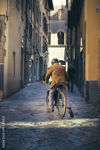 Alter Mann auf einem Fahrrad in der Altstadt, Italien.