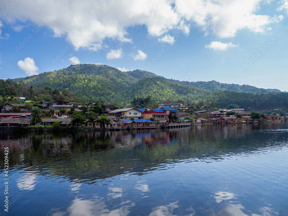 The beautiful lake and house reflection on the water at Ban Ruk Thai, which Yunnan Chinese Village at Mae Hong Son, Thailand.