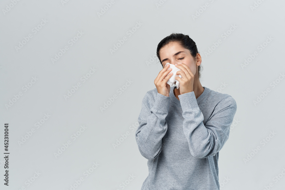 woman wiping her nose with a handkerchief flu health problems treatment woman wiping her nose with a handkerchief flu health problems treatment