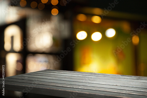 empty wooden table on blurred light gold bokeh cafe restaurant bar  place for your products on the table.