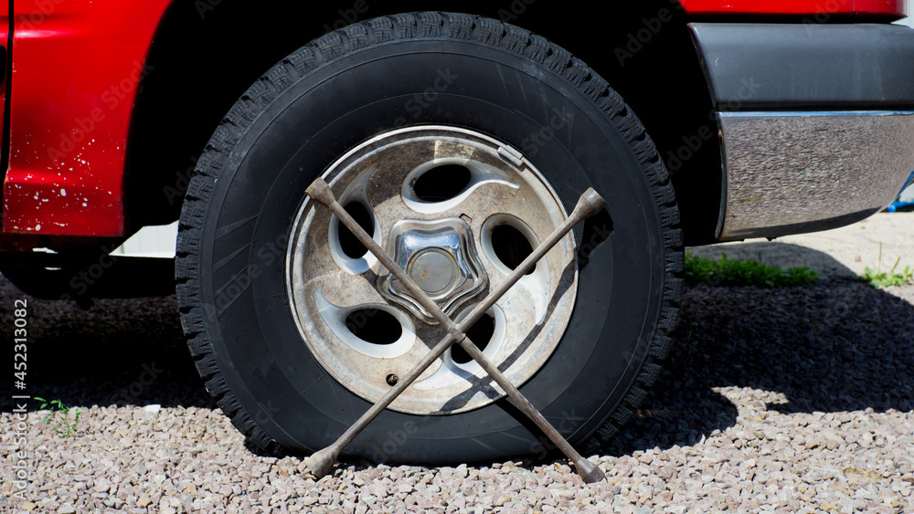 A Flat Tire and Lug Wrench
