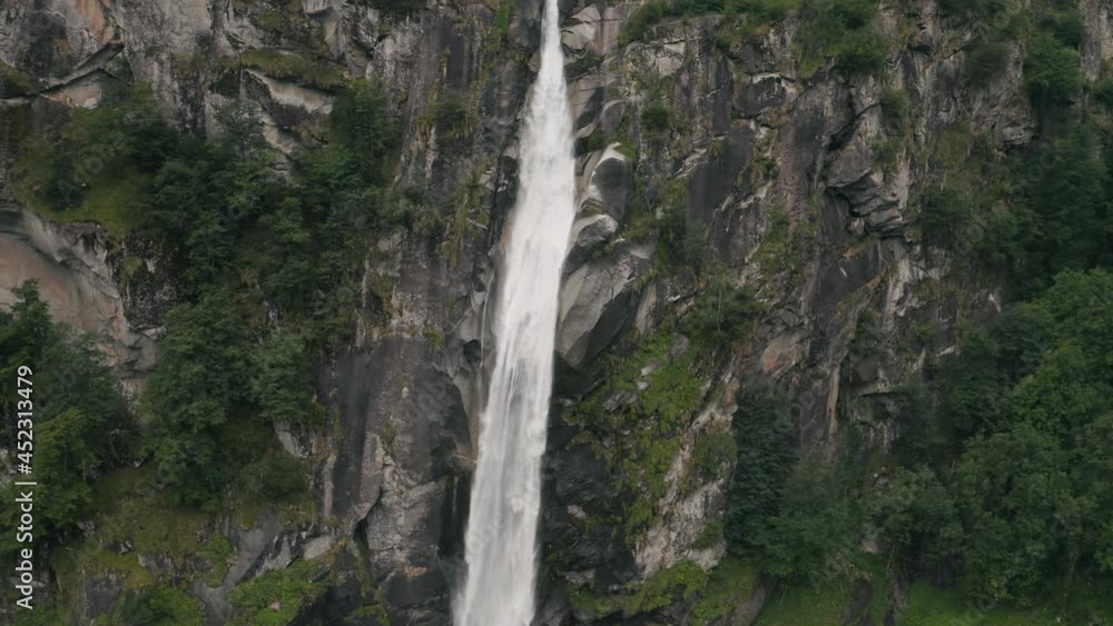 Aerial view of an incredible steep waterfall surrounded by the lush vegetation of the forest near Cevio, Ticino, Switzerland. Aerial view of an incredible steep waterfall surrounded by the lush vegetation of the forest near Cevio, Ticino, Switzerland.