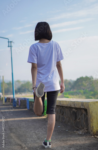 Young Asian woman has  streaching before doing jogging and running in the morning