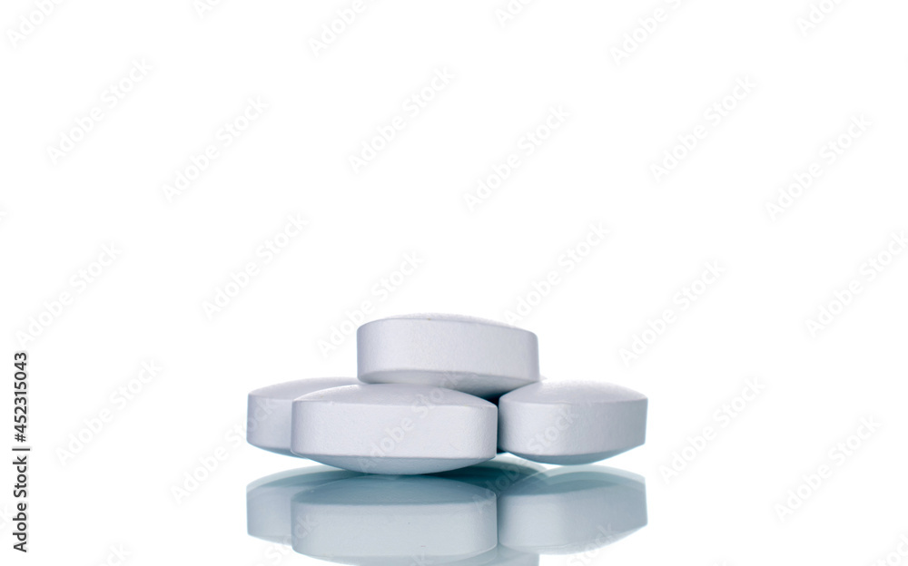 Several vitamin tablets, close-up, isolated on white. Several vitamin tablets, close-up, isolated on white.