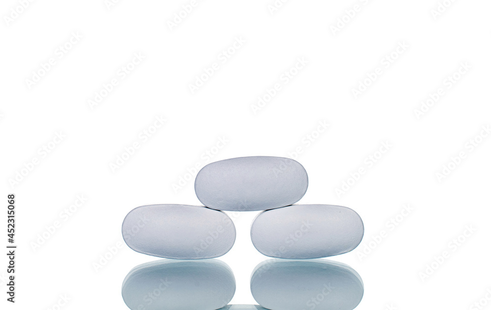 Several vitamin tablets, close-up, isolated on white. Several vitamin tablets, close-up, isolated on white.