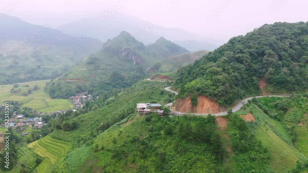 Aerial Forward Shot Of Cars Moving Over Road Amidst Plants On Mountain - Mu Cang Chai, Vietnam Aerial Forward Shot Of Cars Moving Over Road Amidst Plants On Mountain - Mu Cang Chai, Vietnam