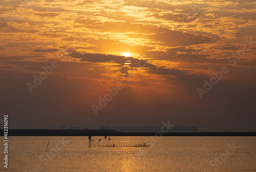 Sunrise at Busaiteen coast with a traditional fishing net called Hadra, Bahrain