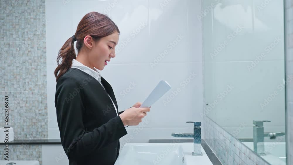 Asian applicant prepare for job interview in front of mirror at home.