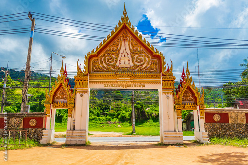 Colorful architecture of entrance gate Wat Ratchathammaram temple Thailand. photo