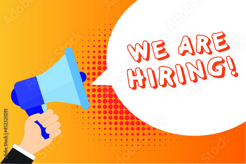 Male hand holding megaphone with We are Hiring! speech bubble. Loudspeaker. Banner for business, marketing and advertising. Vector illustration.