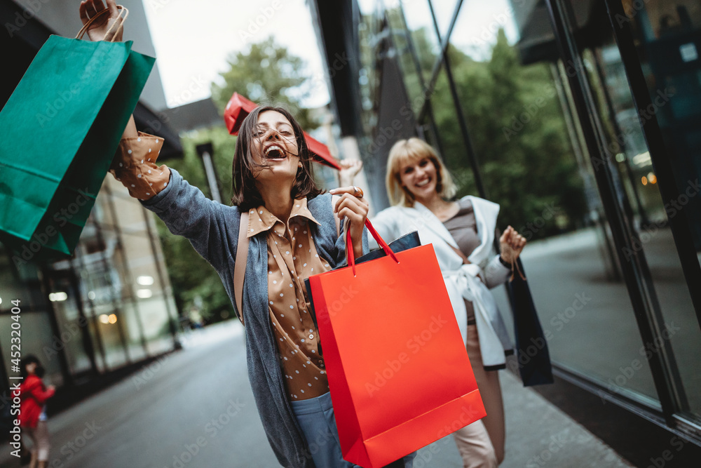 Ταπετσαρία Beautiful happy women with shopping bags walking and having fun