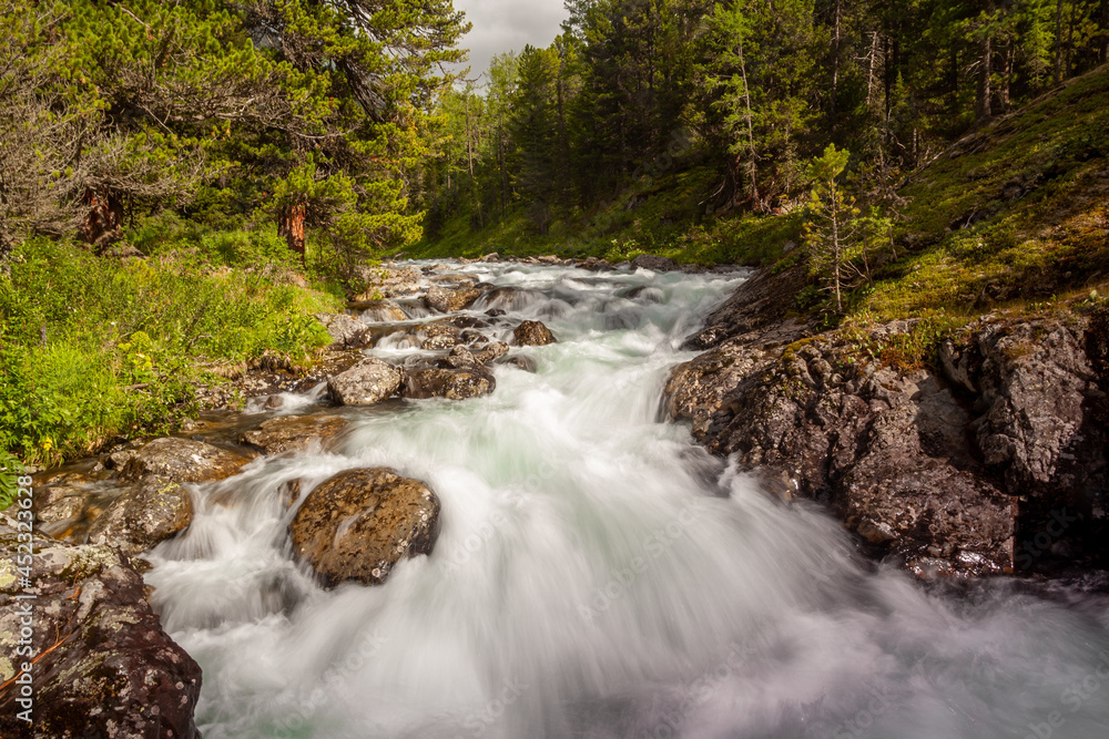 Mountain river with a waterfall